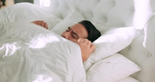 Bedroom, wake up and tired man frustrated with annoying morning sound or alert in the room