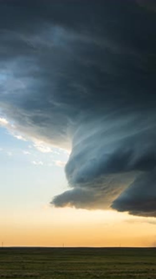 Dramatic Storm Clouds and Rain over Golden Field