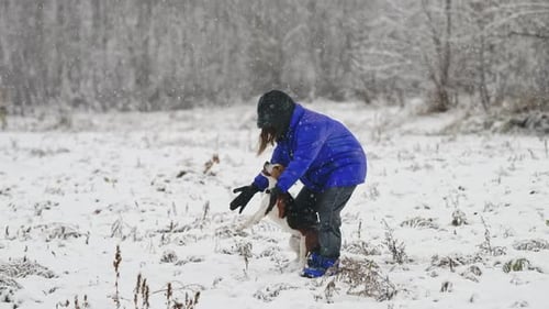 Woman Playing with Little Beagle Puppy on Winter Nature Area Countryside