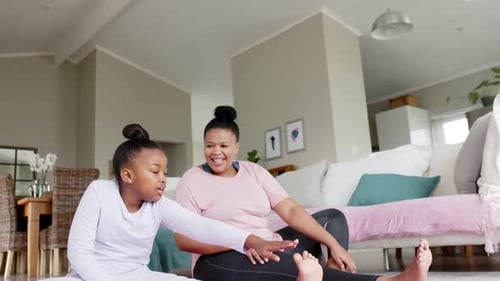 Woman and Child Stretching Legs at Home