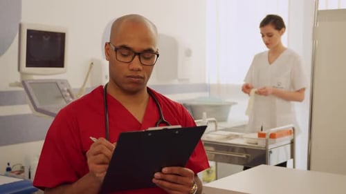 Healthcare Workers Doing Paperwork and Preparing Gloves in Hospital