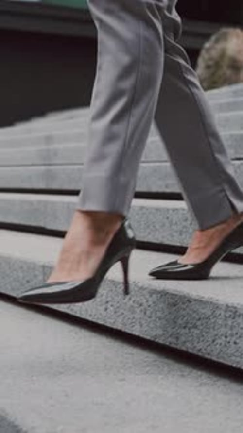 Close Up of Woman of Suit and Heels Walking Down Stairs