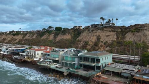 Aerial view of waves hitting luxury homes on the coastline of San Clemente, USA