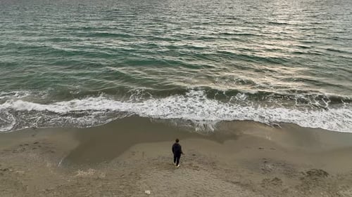 Serene Sunset Reflections Cinematic Drone Films Guy Lost in Thought Witnessing the Sea's Splendor
