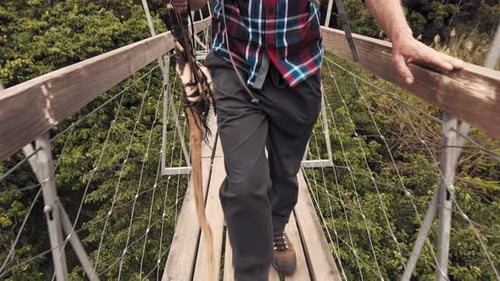 Trekker on Mountain Suspension Bridge Walk