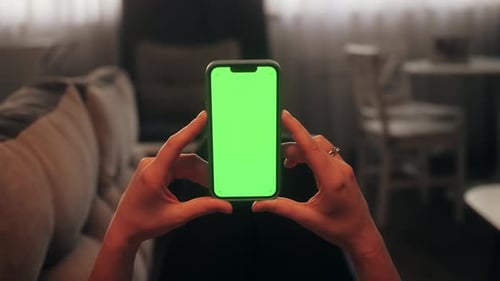 Person Lying on Sofa in Living Room and Using Smartphone with Chroma Key