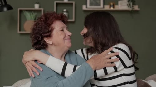 Affectionate Senior Woman Embracing Young Adult Woman