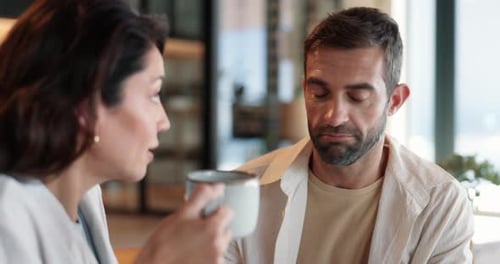 Friends Talking Over Coffee Inside a Cafe
