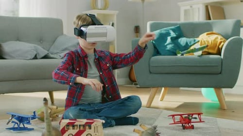 Boy with VR headset sitting on living room floor