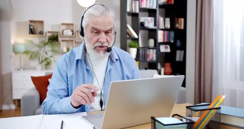 Senior Man Using Laptop for Video Call at Home