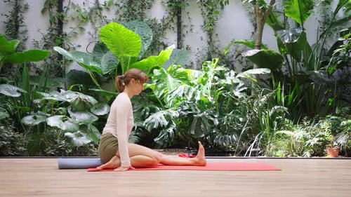 Woman in mindful supine twist in modern studio