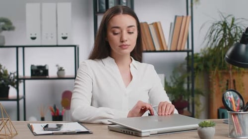 Businesswoman Working on Laptop Meditating Doing Yoga Breathing Exercise in Lotus Position at Office