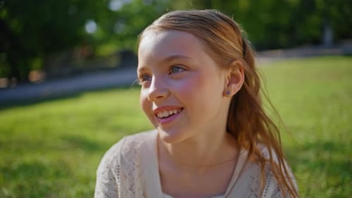 Smiling Kid Resting Summer Sitting at Grass Closeup Child Relaxing on Sunshine