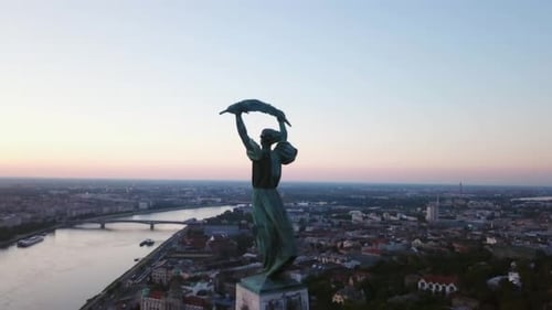Budapest liberty statue and view of the early sun over the city