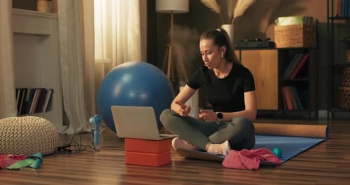 Woman Works Out at Home with Online Trainer