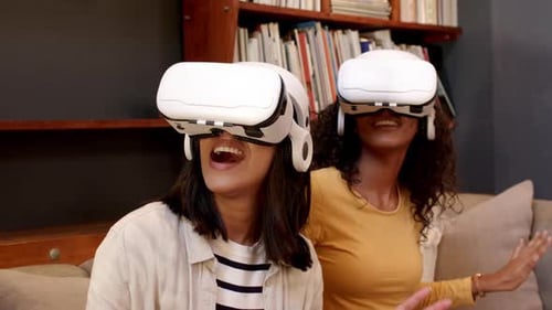 Excited Women Experiencing Virtual Reality Headsets at Home