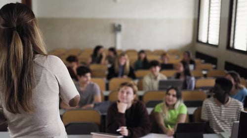 Young students listening a lesson in high school - School education concept