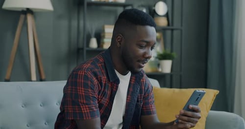 Man Talks on Smartphone Video Call at Home