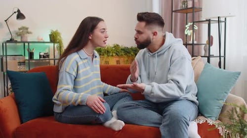 Couple Arguing on Couch in Living Room