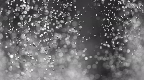 Floating abstract particle bokeh on dark background. Shot on super slow motion camera 1000 fps.