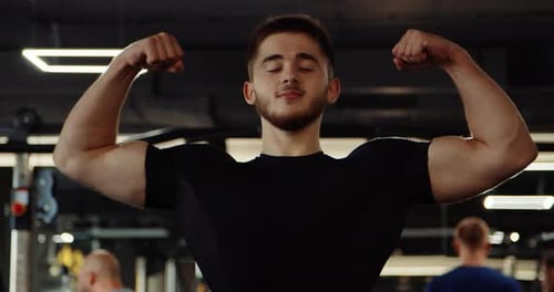 Medium Shot of Athletic Handsome Young Man Performing Bench Press in Gym Man Wears Black Long Sleeve