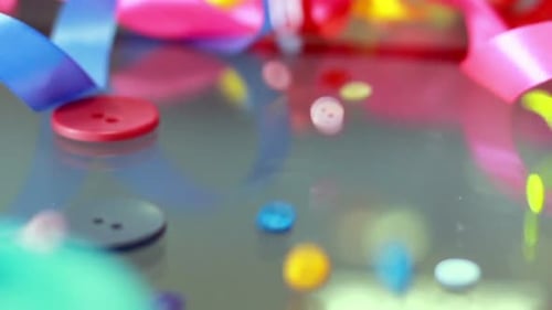 Sewing Buttons Falling on Glass Table. Closeup. Sewing Supplies. Mixed Colored Bright