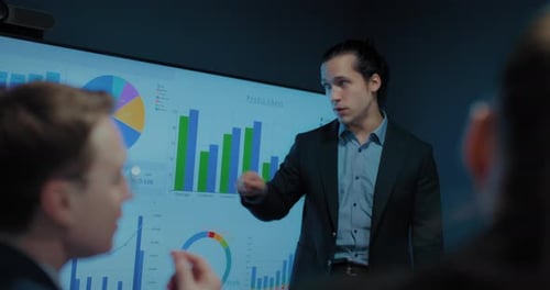 Confident Man Presents Data at Corporate Meeting