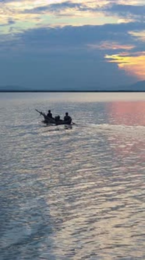 Silhouette of People Fishing on Lake at Sunset
