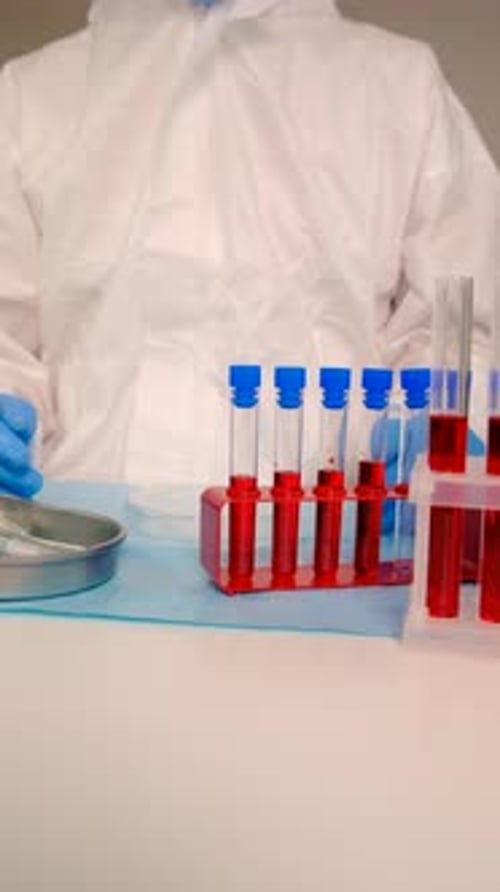 Scientist Examining Test Tubes in a Laboratory Setting