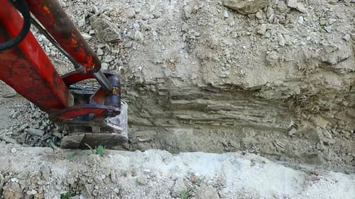 Excavator Digging Trench in Rural Location