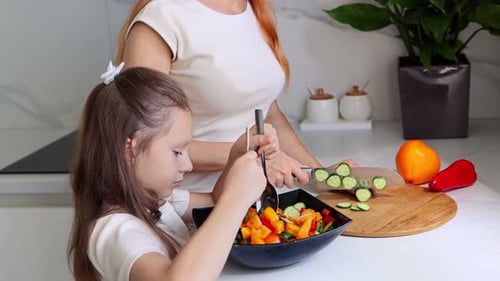 Mother and daughter are preparing a healthy meal together. Concept of organic farm products