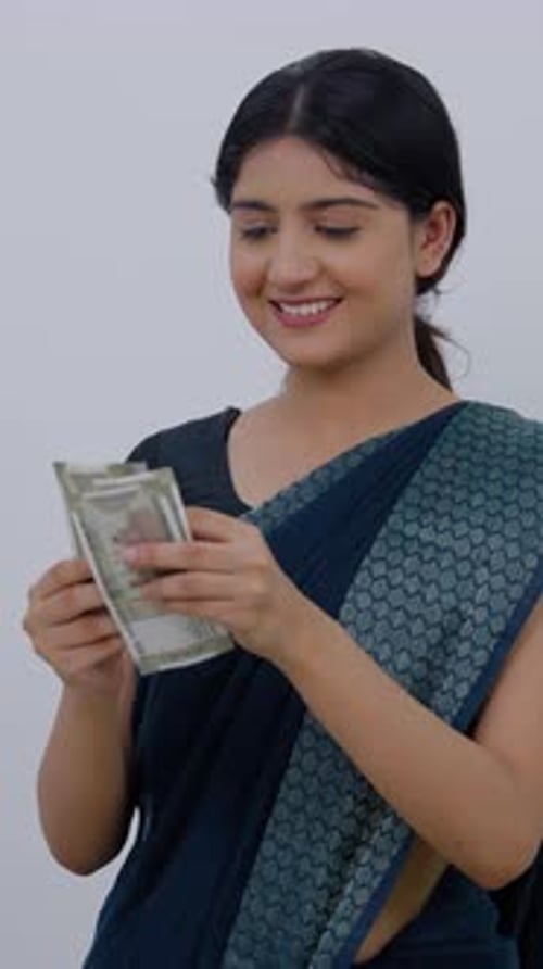 Woman counting money indoors