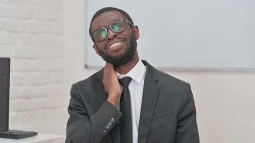 Adult Male Rubbing Stiff Neck in Workplace