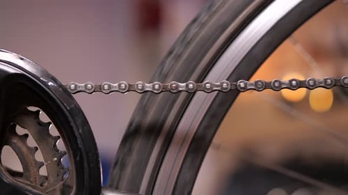 Closeup of Hand Scrolling a Bicycle Pedal Bike Service Dirty Bicycle Chain