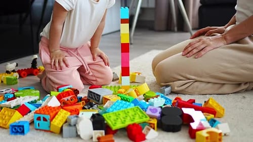 Child and Adult Playing with Building Blocks