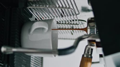 Coffee Machine Pouring Espresso into White Mug
