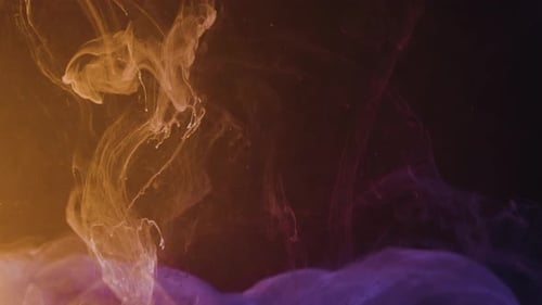 Slow motion of falling colorful paint ink drops in water against black screen