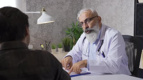 Doctor Explains Diagnosis to Patient in Office