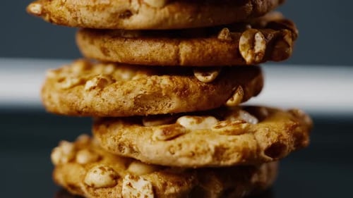 Close Up on Black and Blue Background Flat Plate with Cookie Cookies Built in a Pyramid Sweet