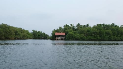 This shot of a single house on the side of the river on Goa, India.
