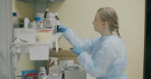 Woman Lab Technician Examining a Medical Bottle