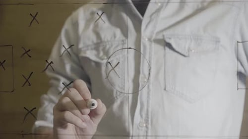 Close Up Manager Drawing Soccer Tactics on Glass Board Using Black Marker