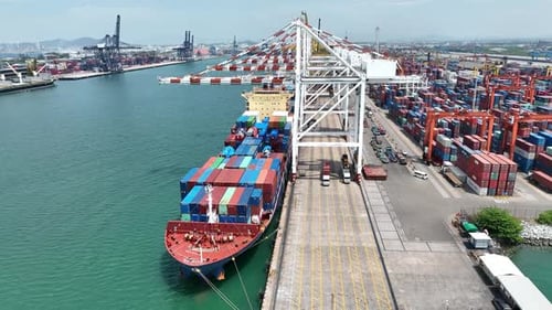 Crane Loading Cargo Container From Truck To Container Ship In The International