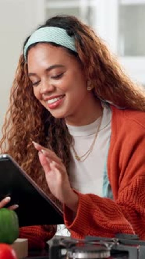 Smiling Woman Using Tablet in Kitchen at Home