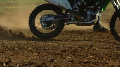 Motocross Bikes Speeding Along Dirt Track