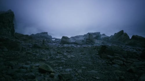 Harsh Terrain Under Gray Sky Gloomy Rocky Field Beneath Somber Clouds