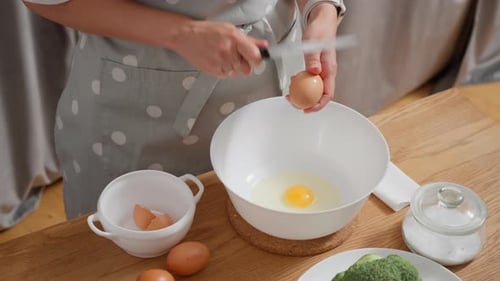 Cracking Fresh Eggs into a Bowl at Home