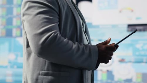 Black Male Entrepreneur Reviews Financial Graphs and KPI Models