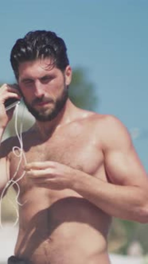 Man Enjoys Tranquil Beach Sunset Sounds Relaxing By Shore While Listening to Calming Music and