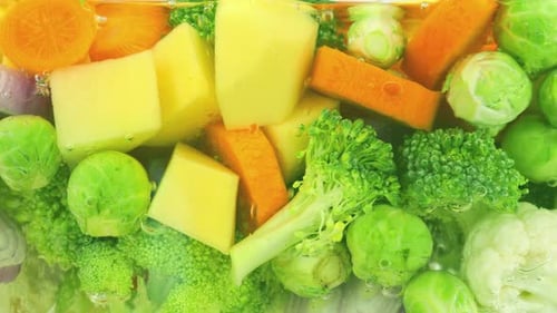 Vegetable mix for making soup in boiling water with air bubbles.